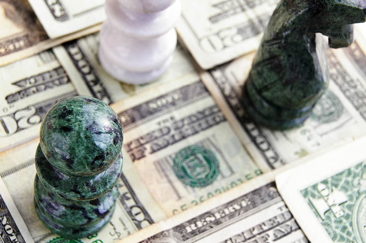 chess pieces arranged on cash squares, from above